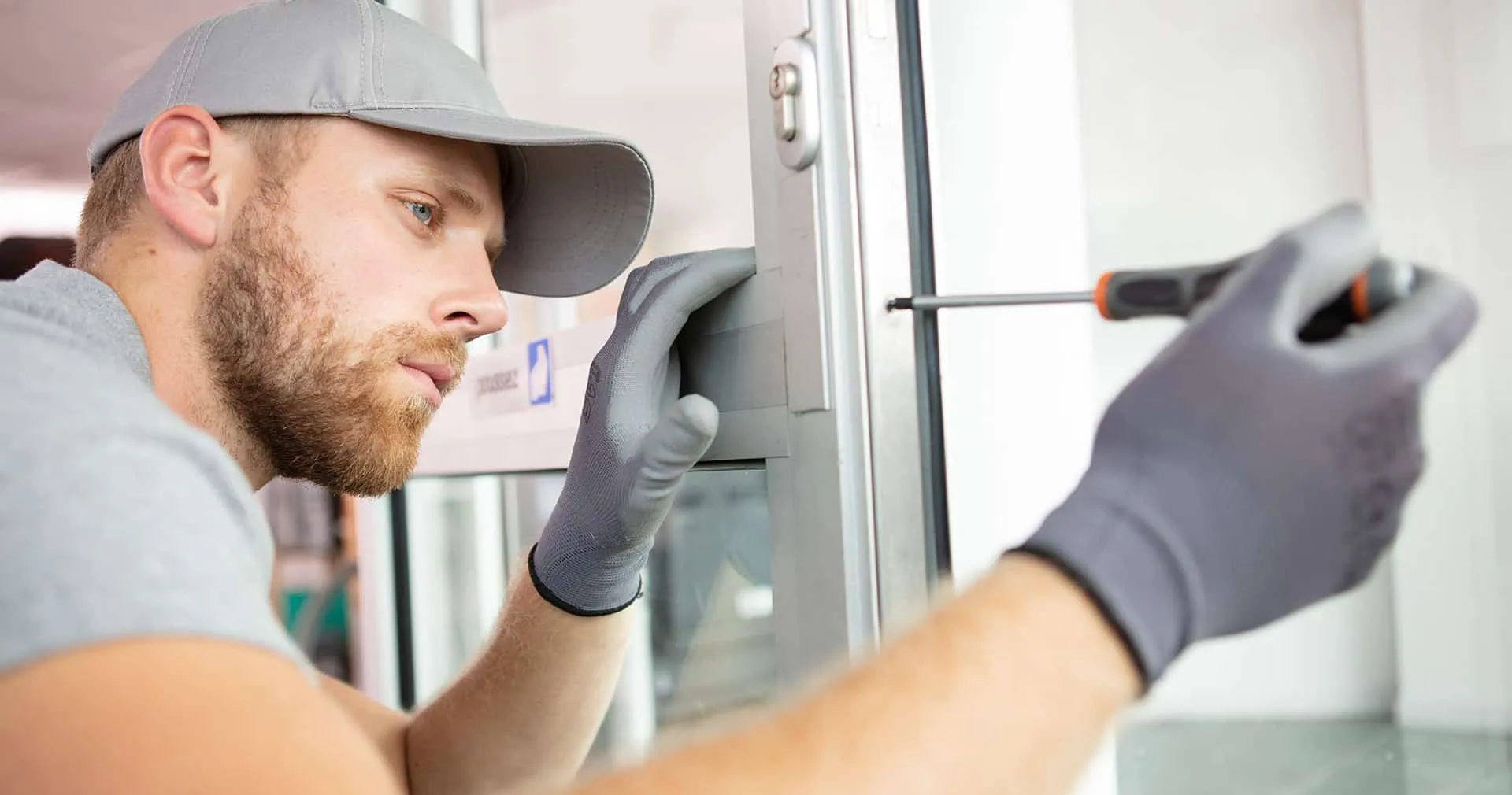 B1 Featured Image Locksmith works on door with screwdriver